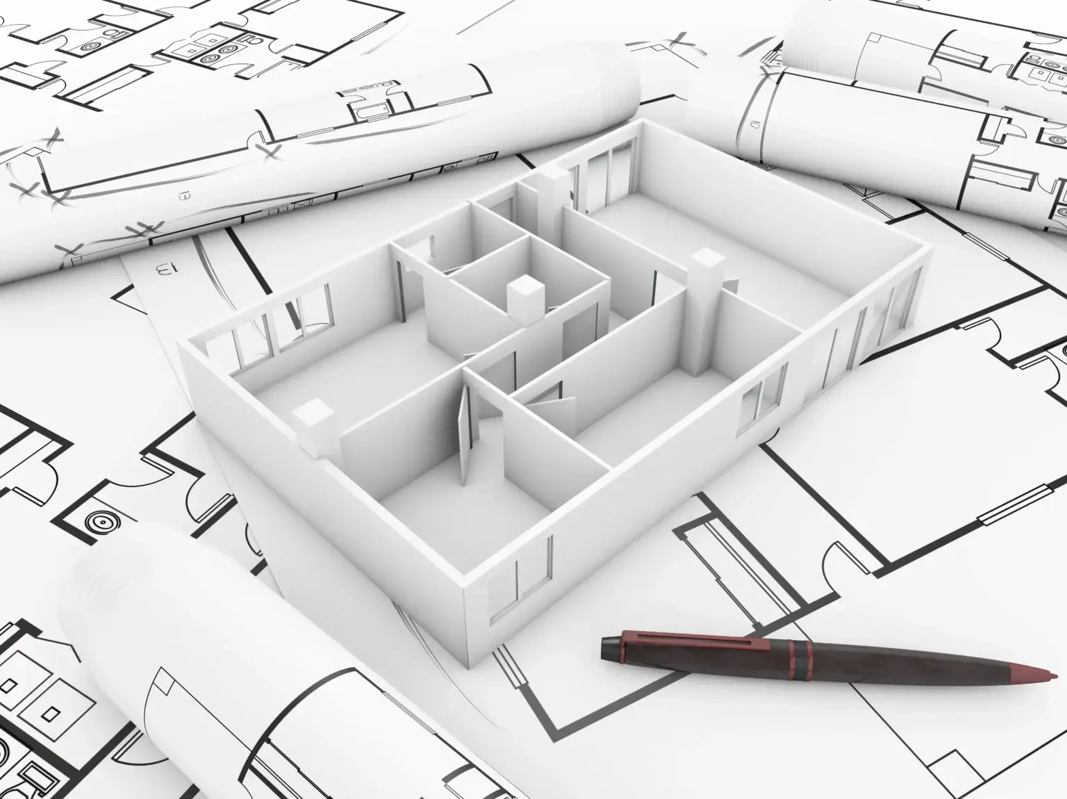Schéma architectural d'une maison avec des plans et un stylo.